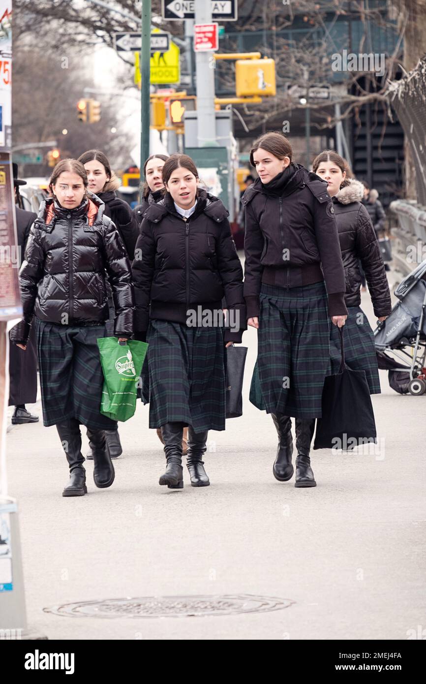 Modestly dressed Hasidic teenage girls wearing long plaided skirts, their school uniforms. In