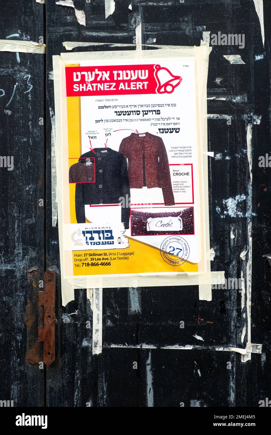 A sign in Yiddish & English warning orthodox Jewish women that some sweaters for sale violate the rules of Shatnez, mixing wool & linen in a garment. Stock Photo