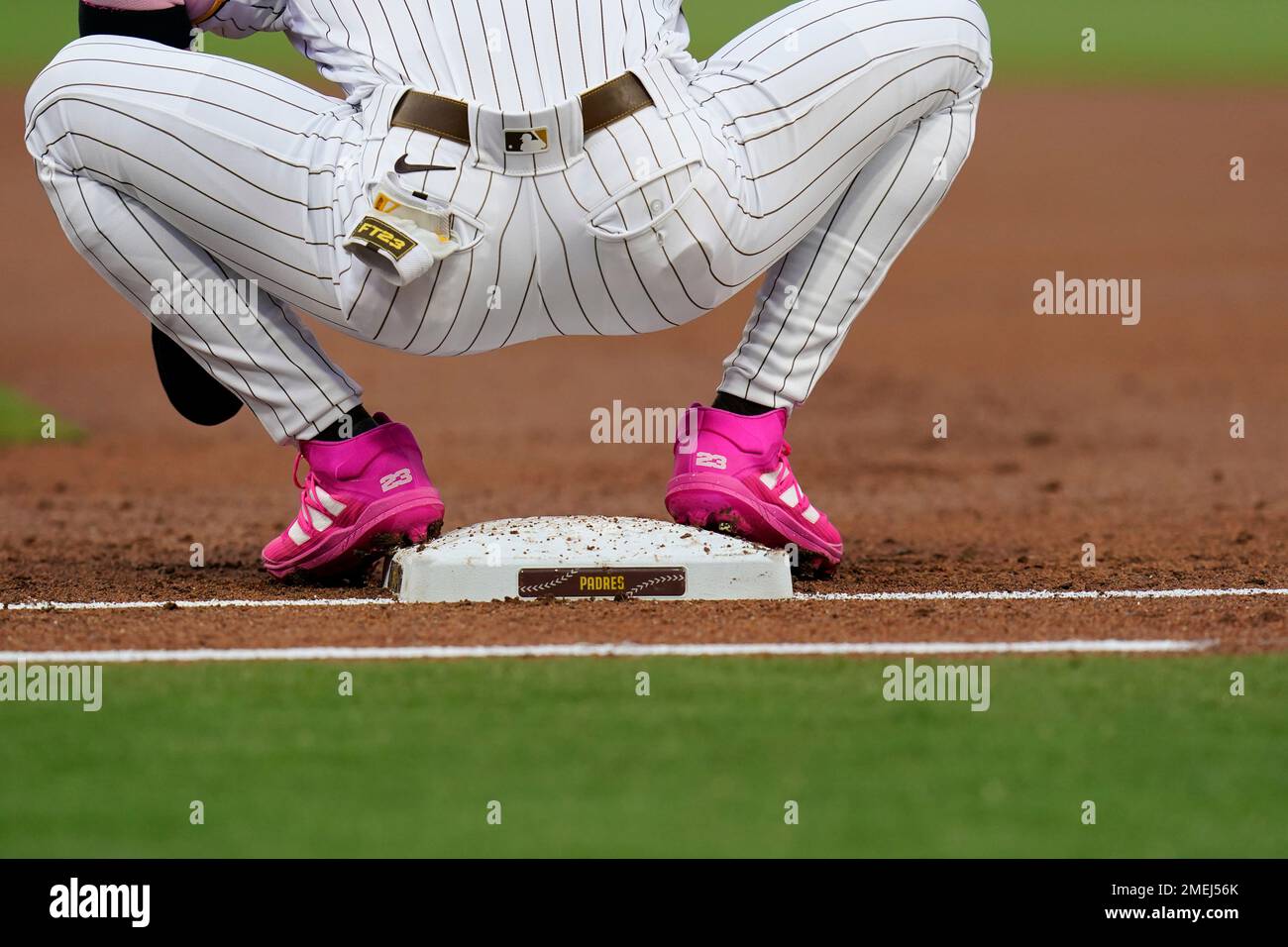 San Diego Padres' Fernando Tatis Jr. wears pink cleats as he stands on  first base after drawing a walk during the first inning of a baseball game  against the San Francisco Giants