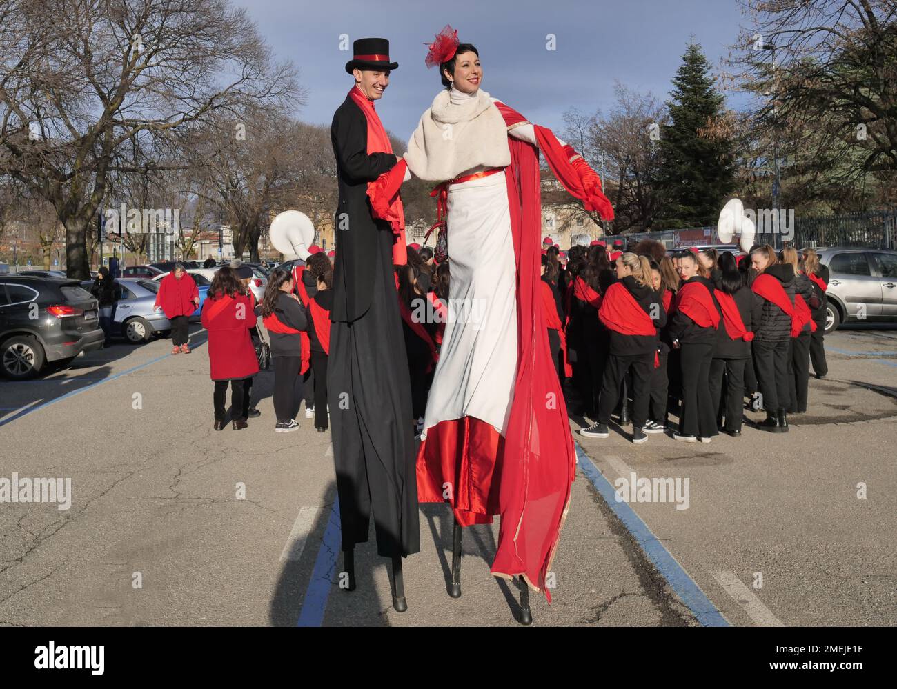 Acrobats and stilt walkers parade through the streets of the city to