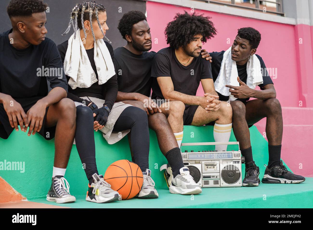 Group of young african people listening music outdoor after basketball match - Focus on center hands Stock Photo