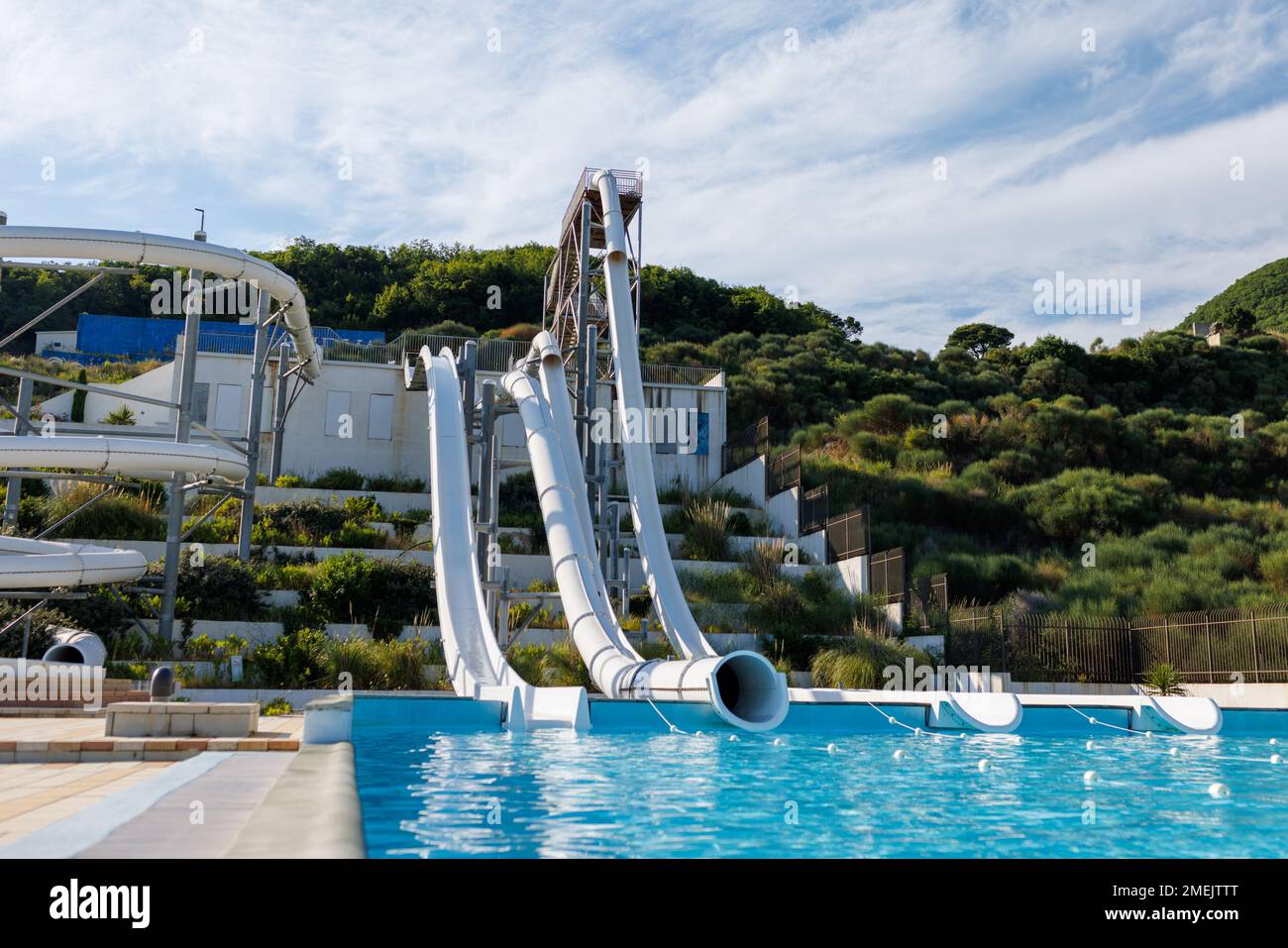 Empty indoor mountain summer water park with high extreme winding white