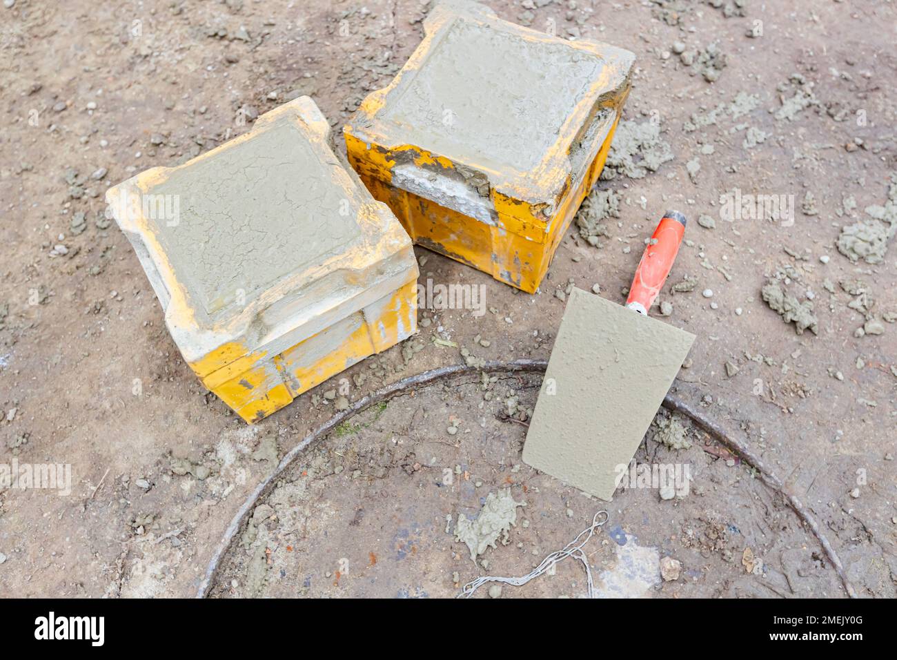 Two cube molds full with concrete, samples for the tensile or flexural testing and compressive strength test of the cement mixture casting building fo Stock Photo