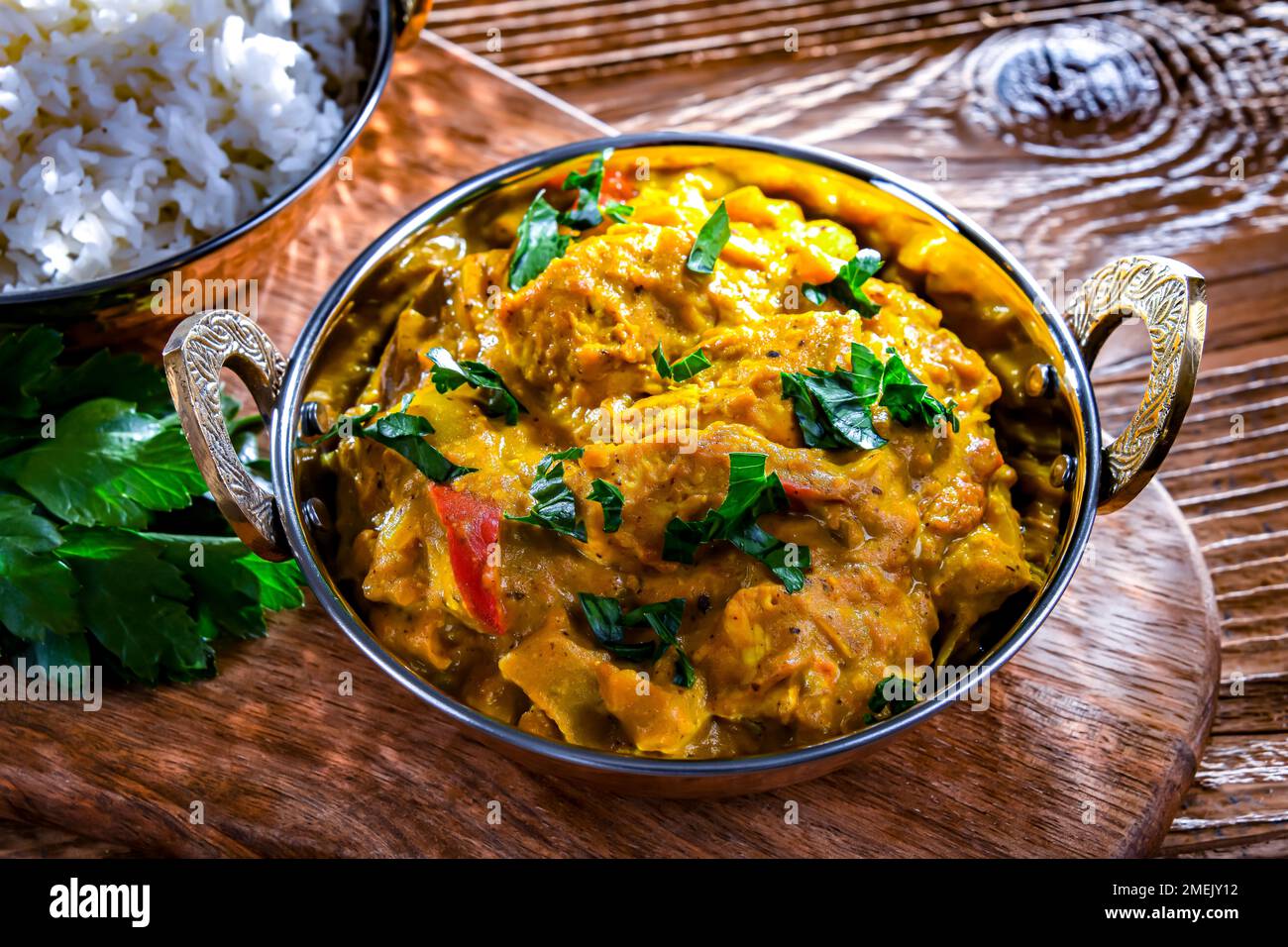 Curry chicken with rice served in original indian karahi pots. Stock Photo
