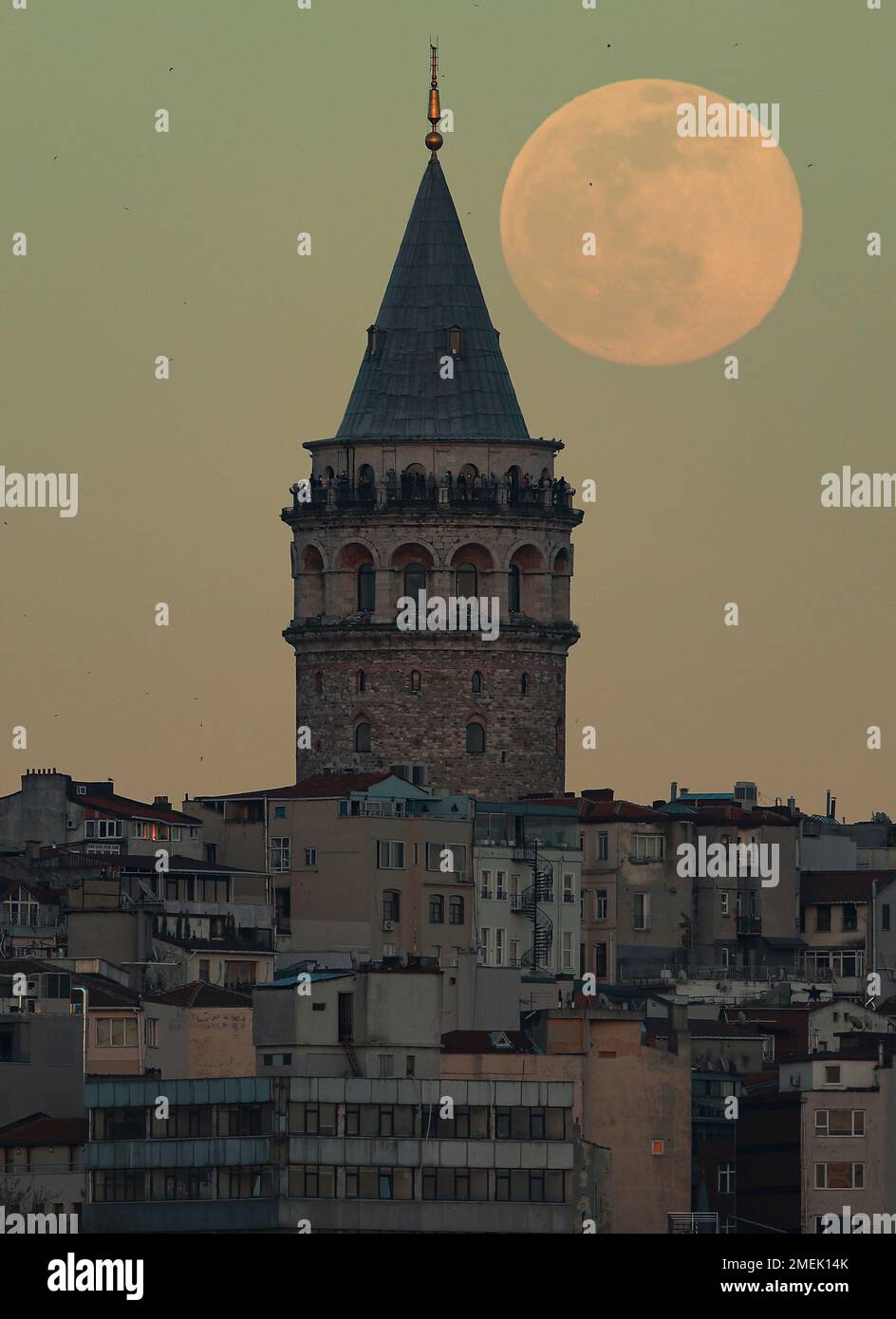 The full moon rises behind Istanbul's iconic Galata Tower, Monday ...