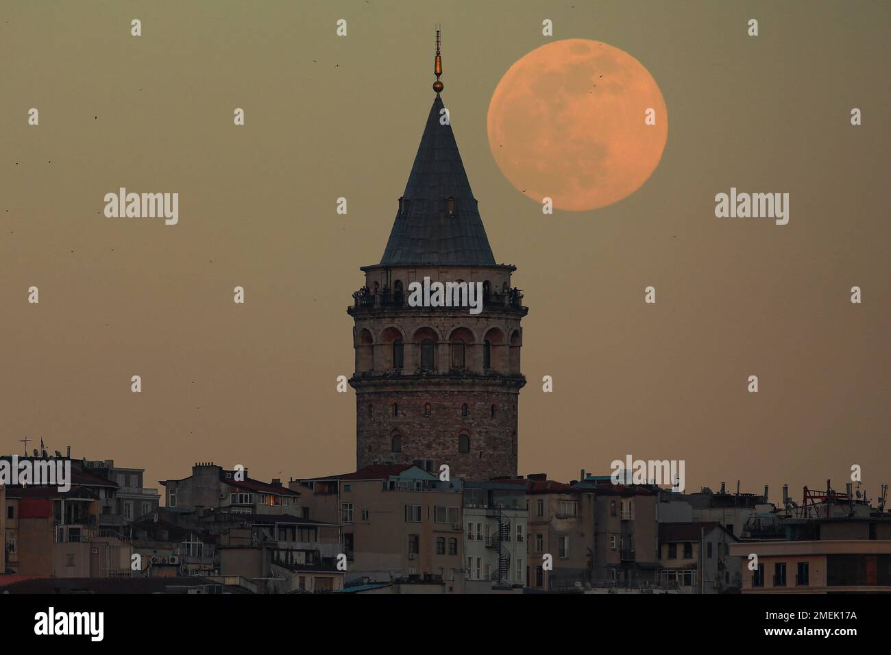 The full moon rises behind Istanbul's iconic Galata Tower, Monday ...