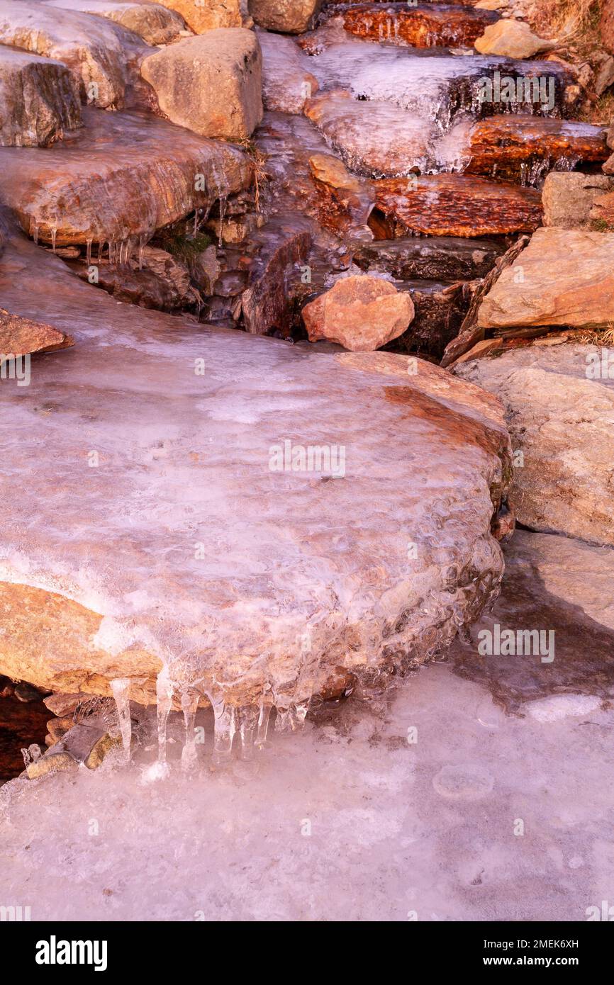 Ice covered stone path in winter, Snowdonia, north Wales Stock Photo