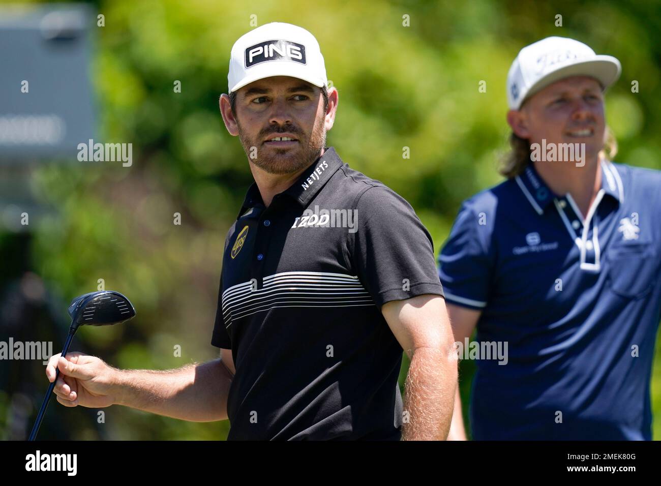 Louis Oosthuizen, of South Africa, left, watches his shot off the second tee during the final round of the PGA Zurich Classic golf tournament at TPC Louisiana in Avondale, La., Sunday, April