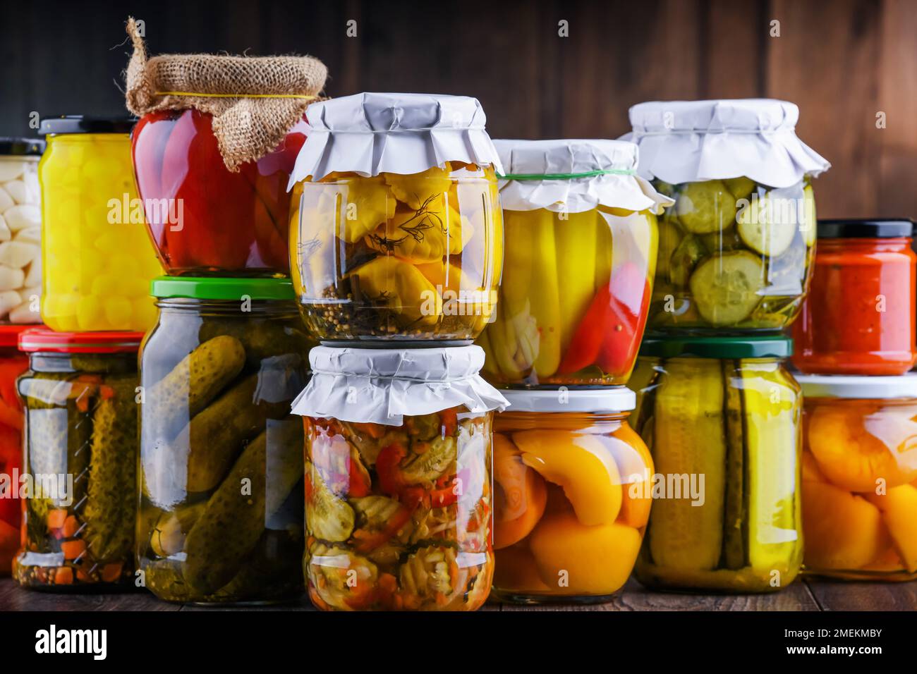 Jars with variety of marinated vegetables and fruits. Preserved food Stock Photo
