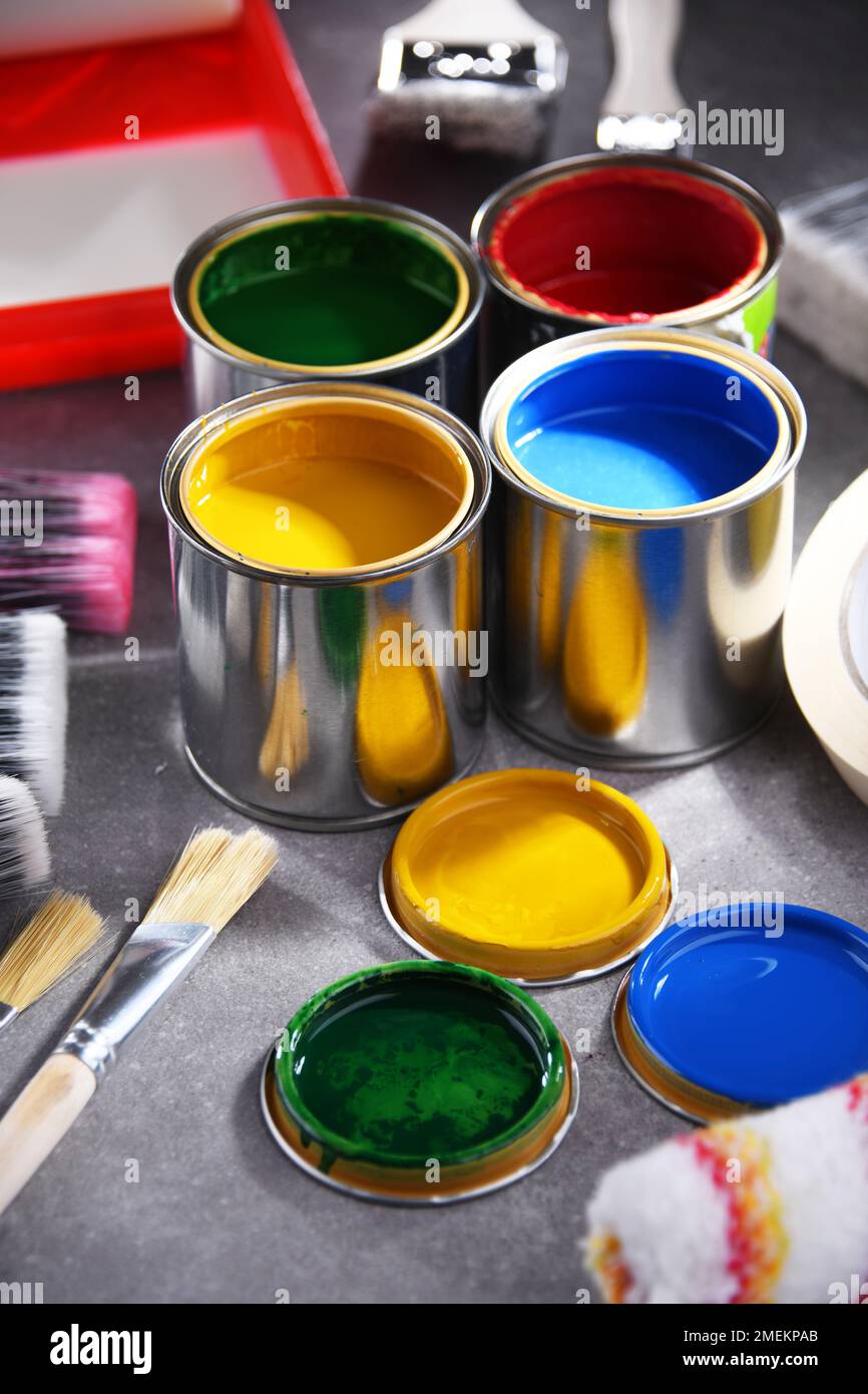 Paint cans and paintbrushes of different size  for home decorating purposes. Stock Photo