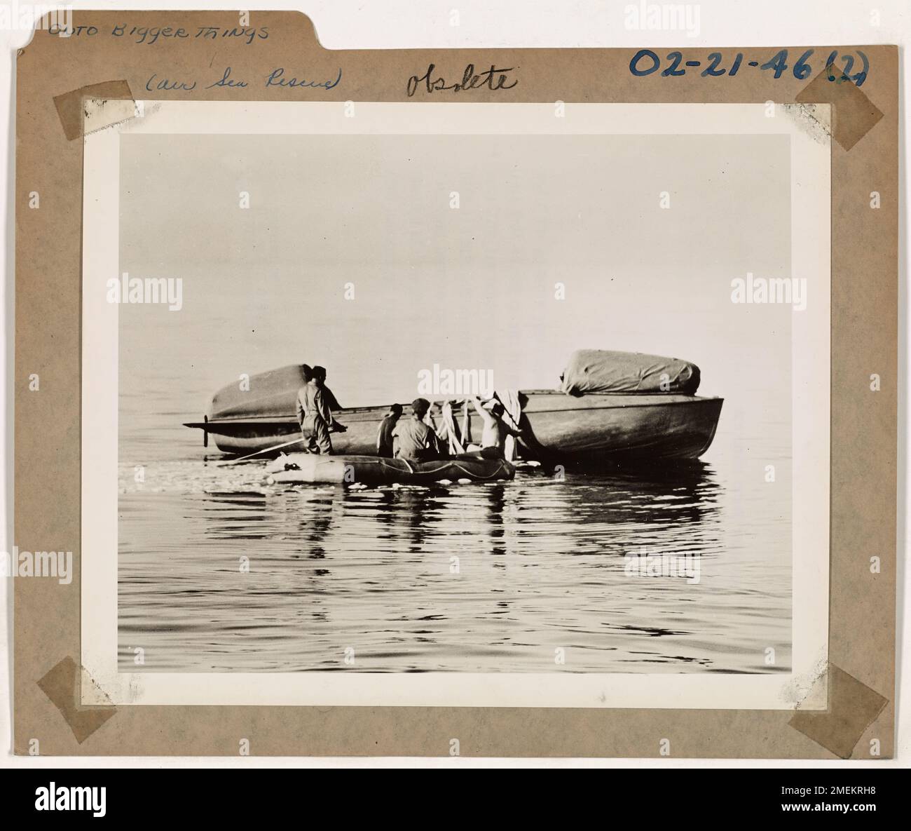 Four airmen, stranded as part of a test of parachuting lifeboats, prepare for rescue or recovery after being dropped from an aircraft during the experiment. Stock Photo