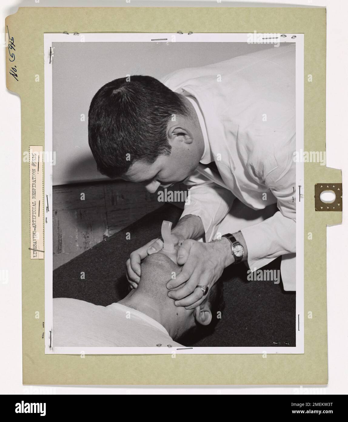A demonstration of the proper technique for mouth-to-mouth resuscitation, highlighting the steps for opening the airway and delivering effective life-saving aid. Stock Photo