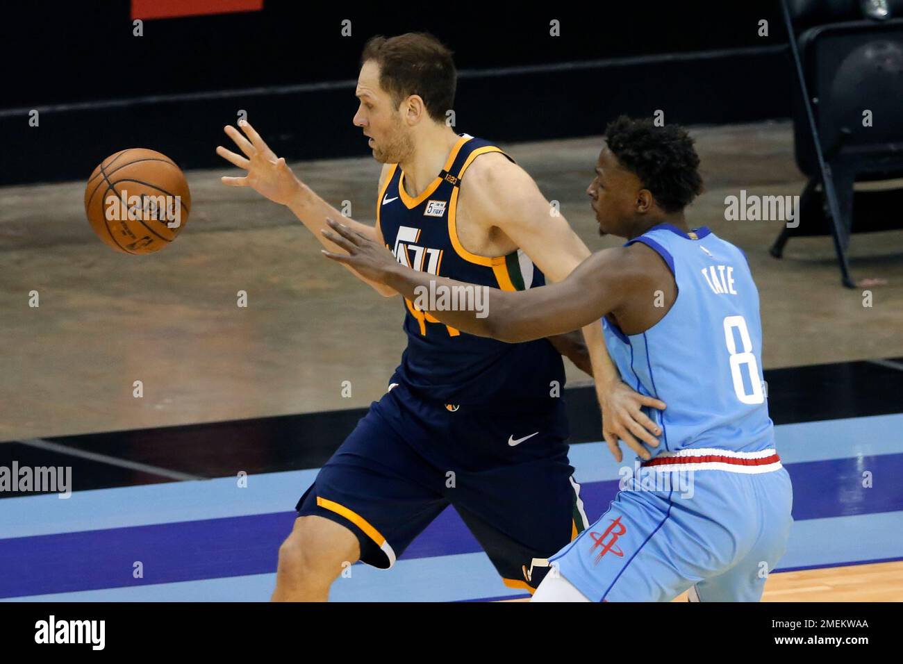 Utah Jazz forward Bojan Bogdanovic, left, loses the ball under pressure  from Houston Rockets forward Jae'Sean Tate (8) during the first half of an NBA  basketball game Wednesday, April 21, 2021, in