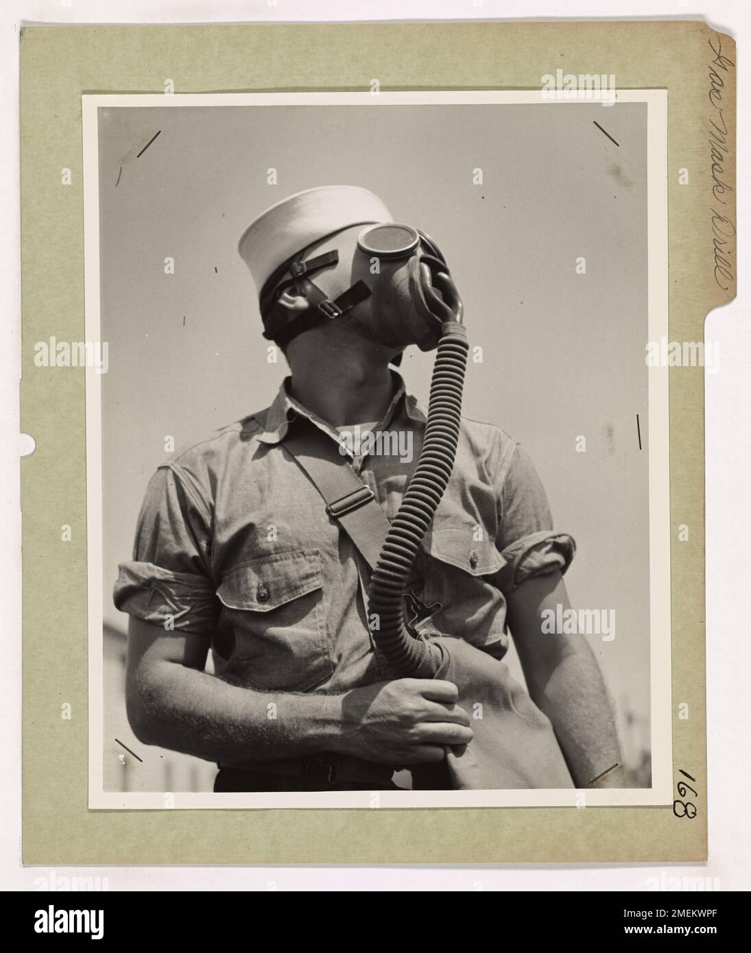 Gas Mask Drill. This image depicts a Coast Guardsman in a gas mask