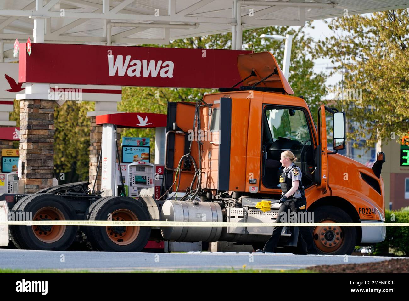 An investigator works the crime scene at a Wawa convenience store and gas station in