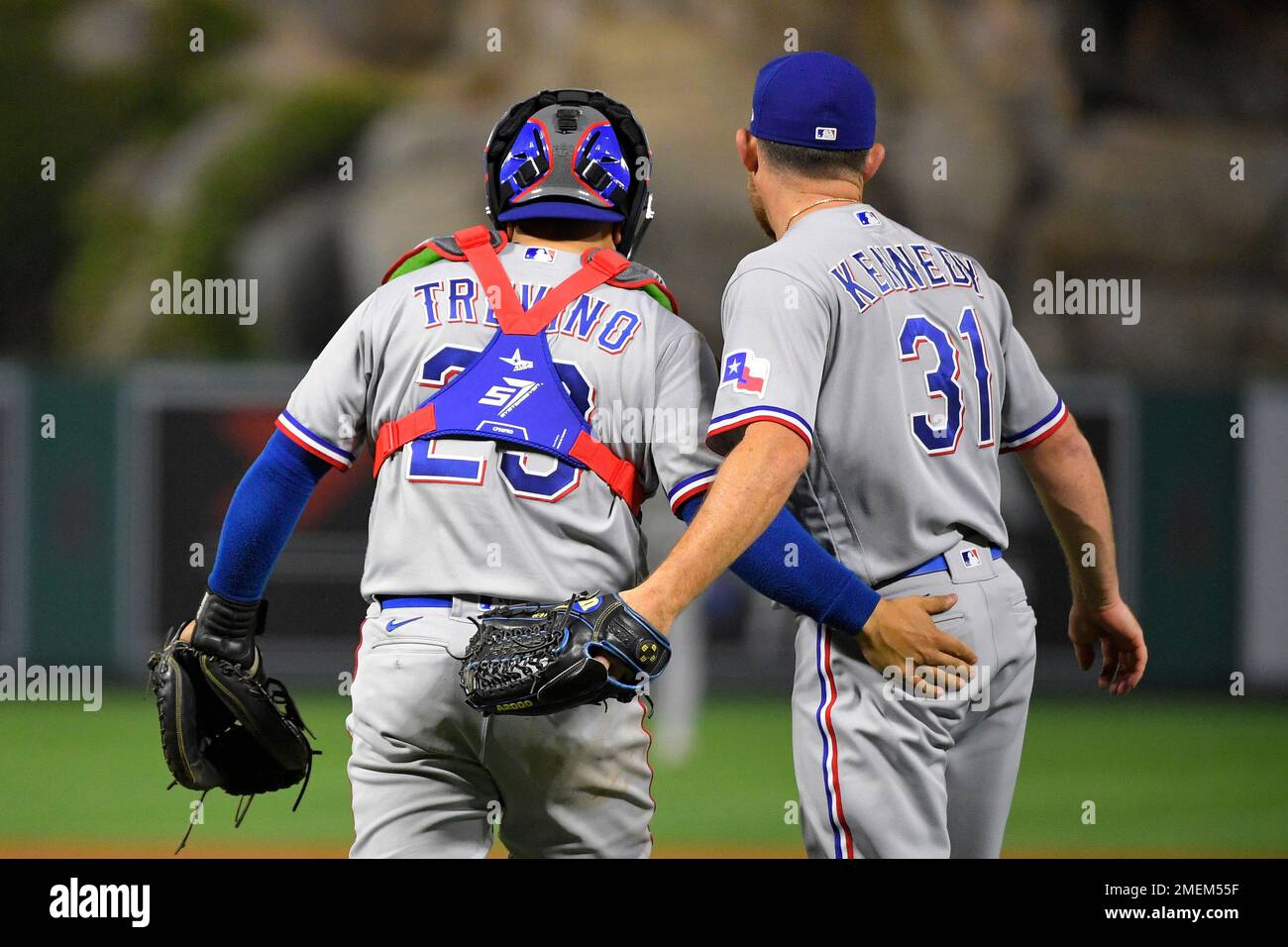 Texas Rangers catcher Jose Trevino, left, and relief pitcher Ian Kennedy,  right, congratulate each other as players celebrate in the background after  the Rangers defeated the Los Angeles Angels 6-4 in a