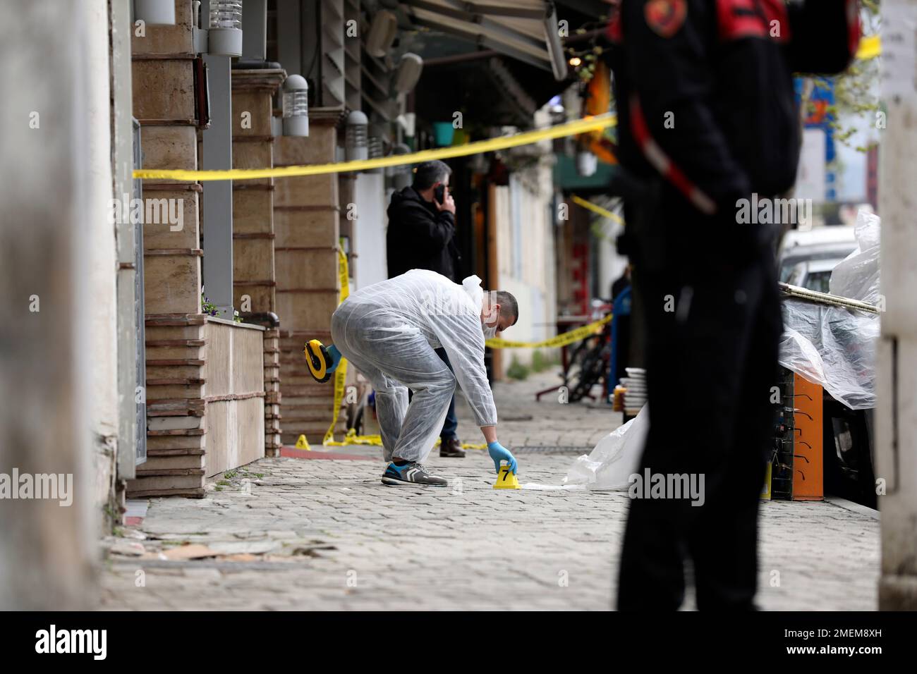 A policeman investigates the area outside Dine Hoxha mosque after a