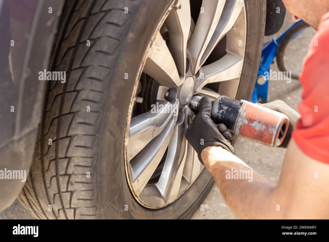 Seasonal Tires Replacement Automotive Photo Theme. Tire Sales Worker
