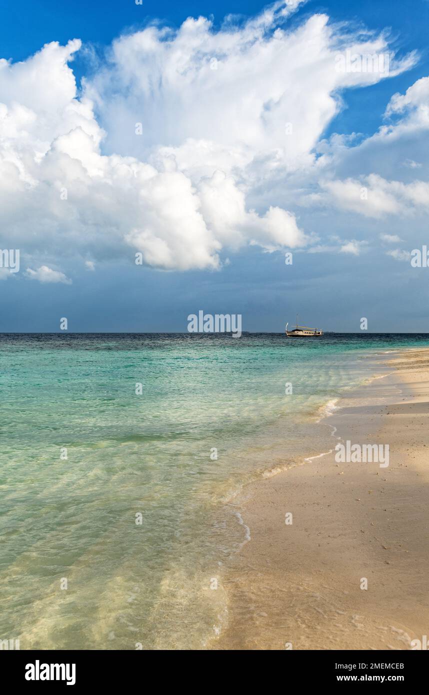 Passing storm above a tropical beach, Baa Atoll, Maldives Stock Photo
