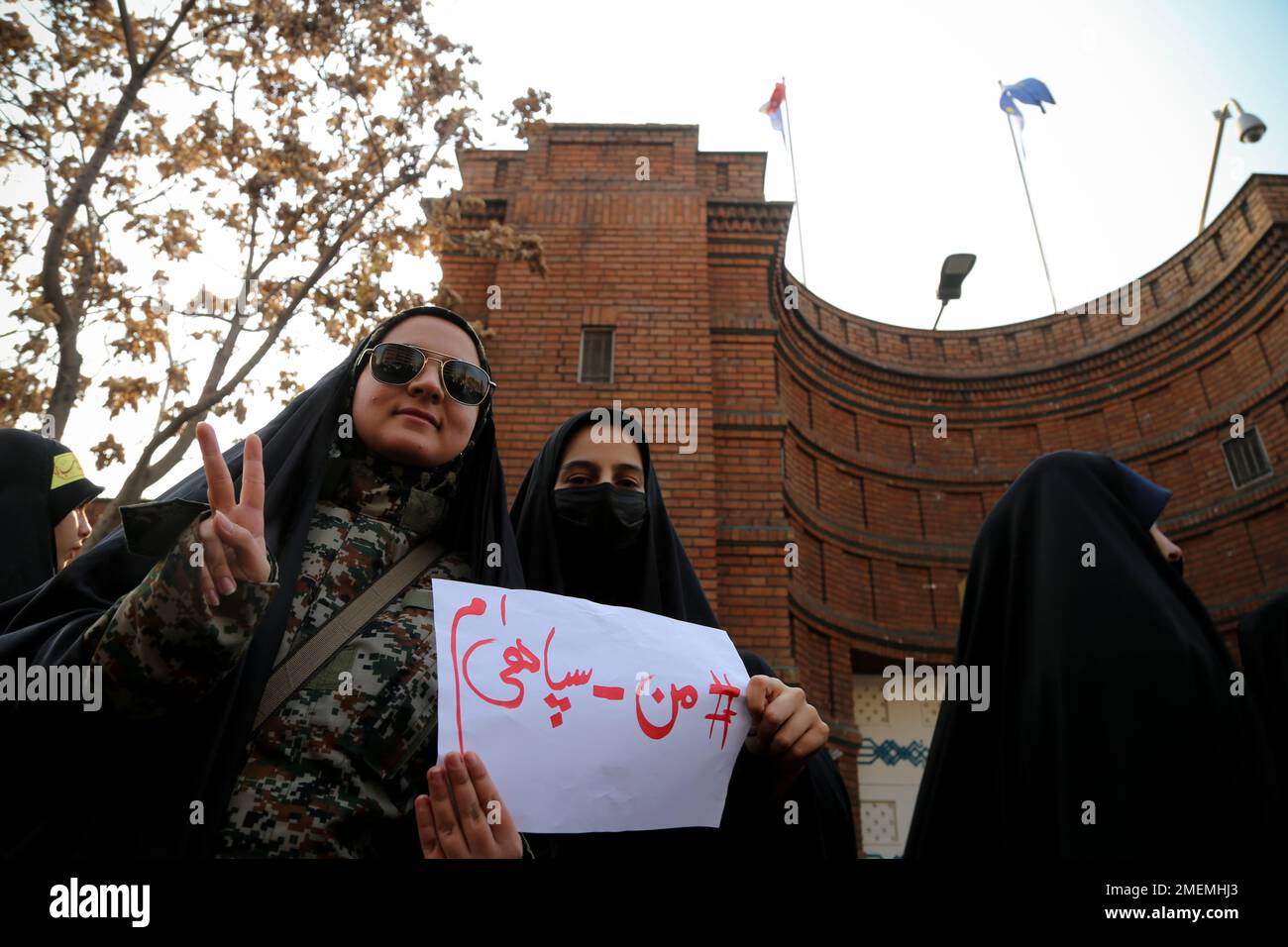 Tehran, Tehran, Iran. 24th Jan, 2023. Iranian veiled female students in black chadors wearing The Islamic Revolutionary Guard Corps (IRGC) uniform, holding a placard written ''I am one of the forces of The Islamic Revolutionary Guard Corps (IRGC)'', gather to protest after Charlie Hebdo published cartoons of Iran's top leader Ali Khamenei in front of the French Embassy in Tehran, Iran on January 24, 2023. Credit: ZUMA Press, Inc./Alamy Live News Stock Photo