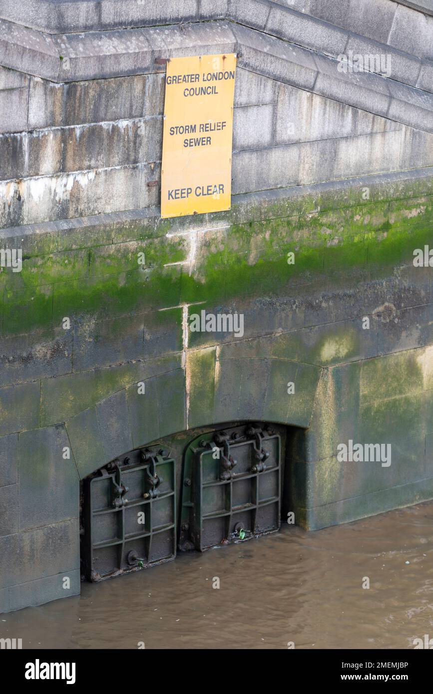 Storm relief sewer discharging into the River Thames near Lambeth Bridge, London, UK. Greater London Council sign. Millbank embankment Stock Photo