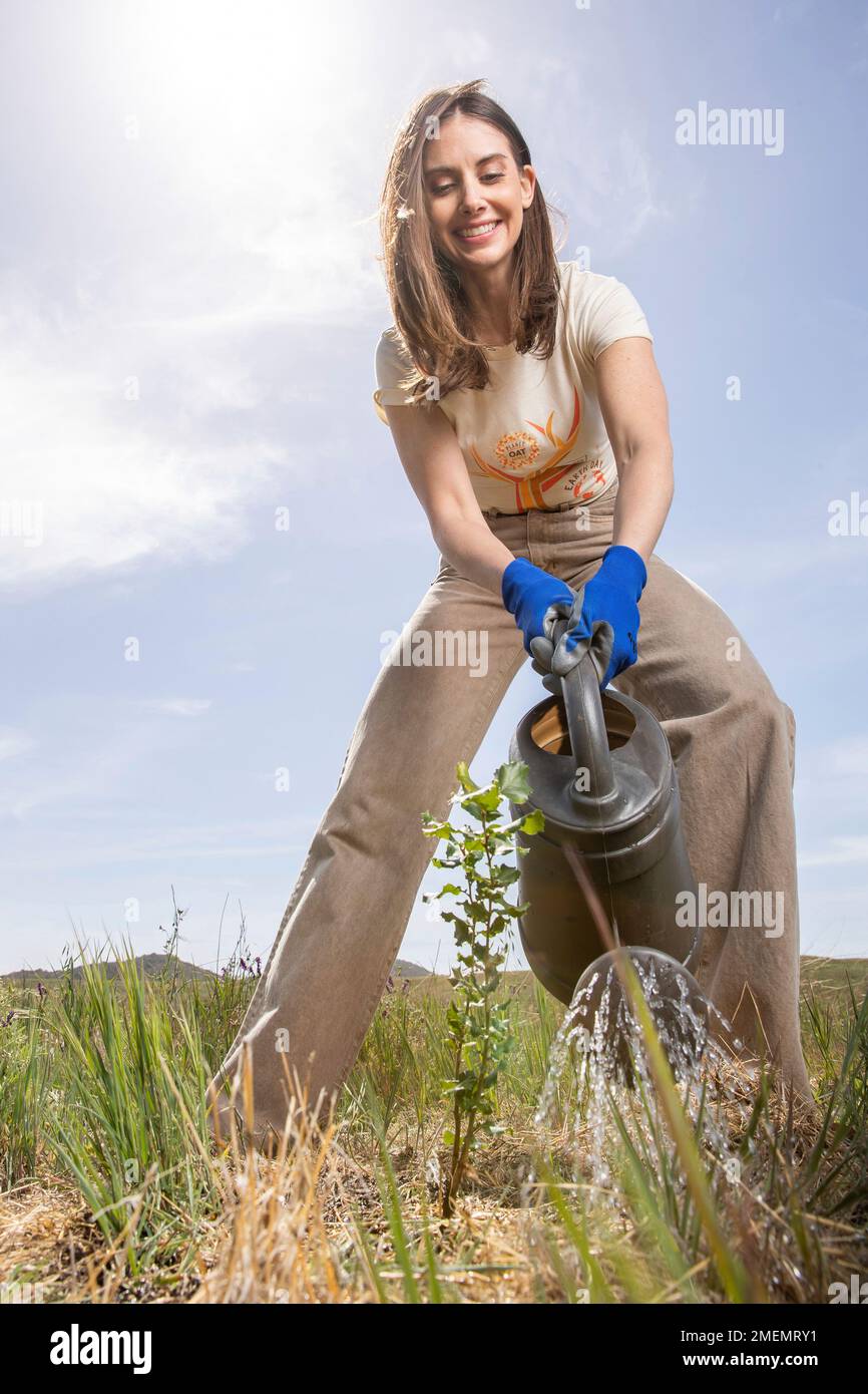 IMAGE DISTRIBUTED FOR PLANET OAT - Alison Brie planting a tree as part