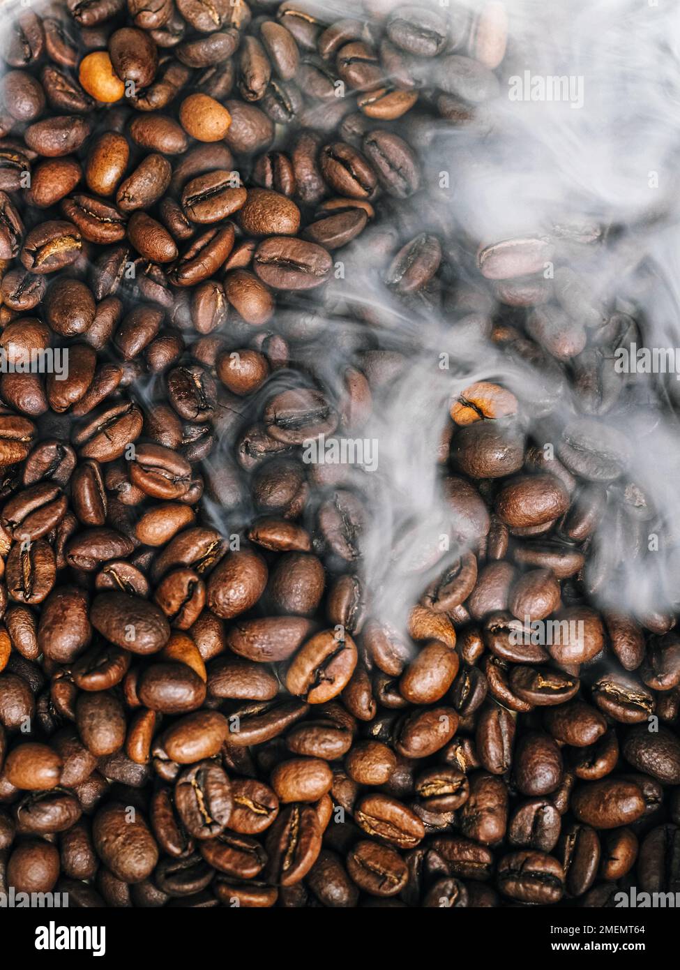 A pile of coffee beans with steam coming out of them Stock Photo