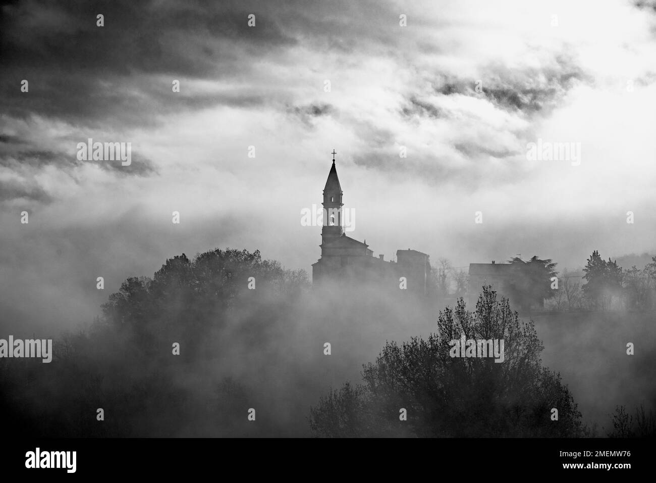 The church of the mystery, an old church in the Tuscan-Emilian Apennines shrouded in fog Stock Photo