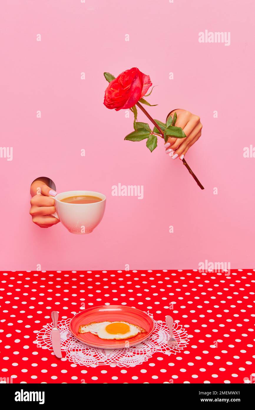 Food pop art photography. Female hand sticking out pink paper with coffee cup and rose flower. Fried eggs for breakfast Stock Photo