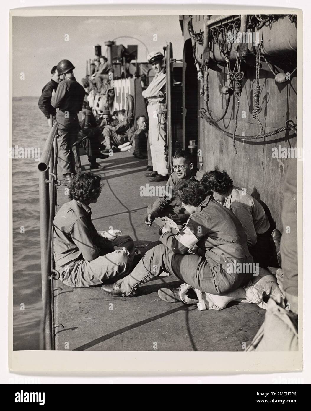 Army nurses aboard a Coast Guard-manned infantry landing craft relax and play bridge while crossing the English Channel, en route to France to care for wounded soldiers. This image shows the lighter side of their journey during World War II operations. Stock Photo