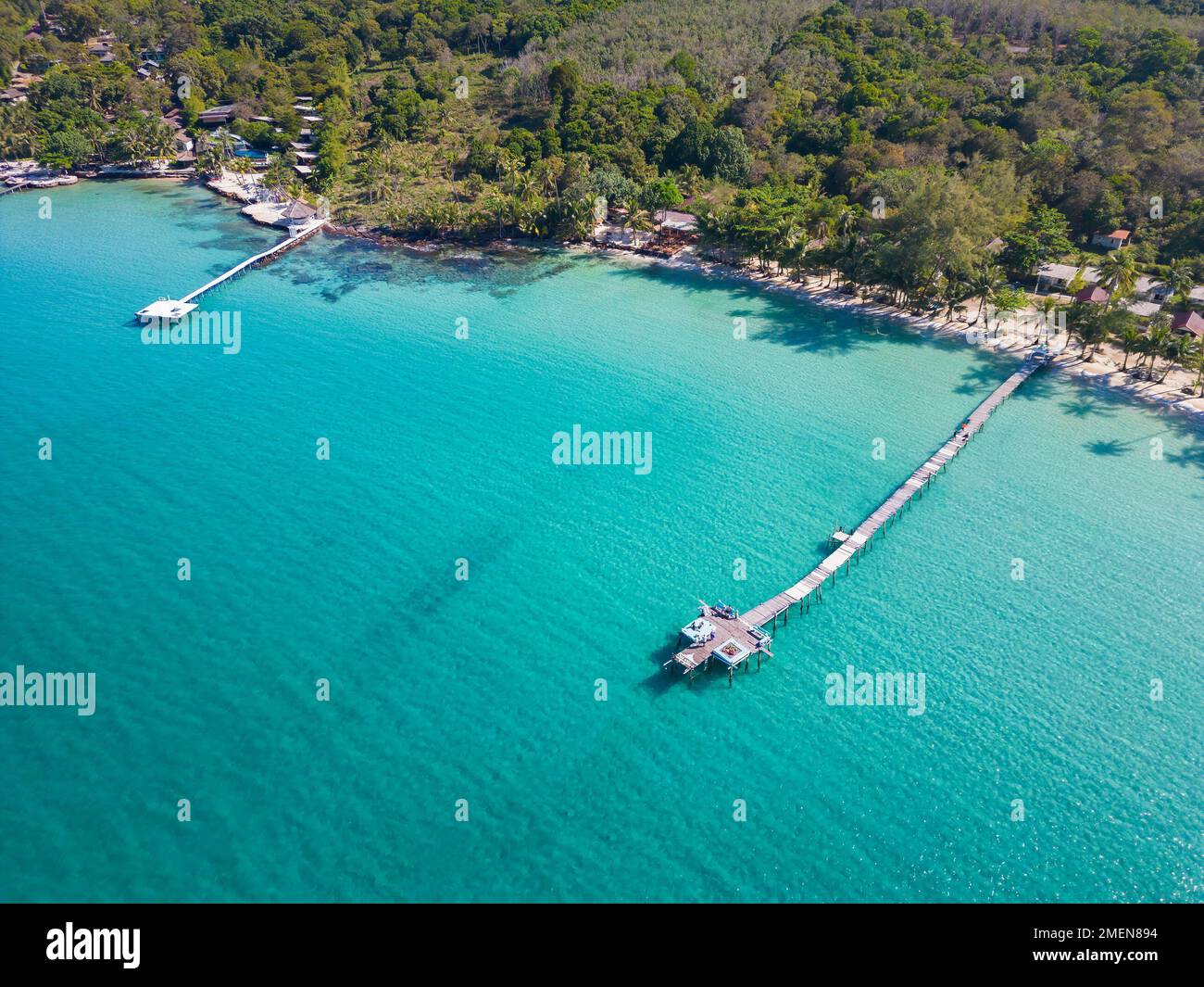 An aerial shot of wooden docks at the Bang bao beach in Koh Kood, Thailand on a sunny day Stock Photo