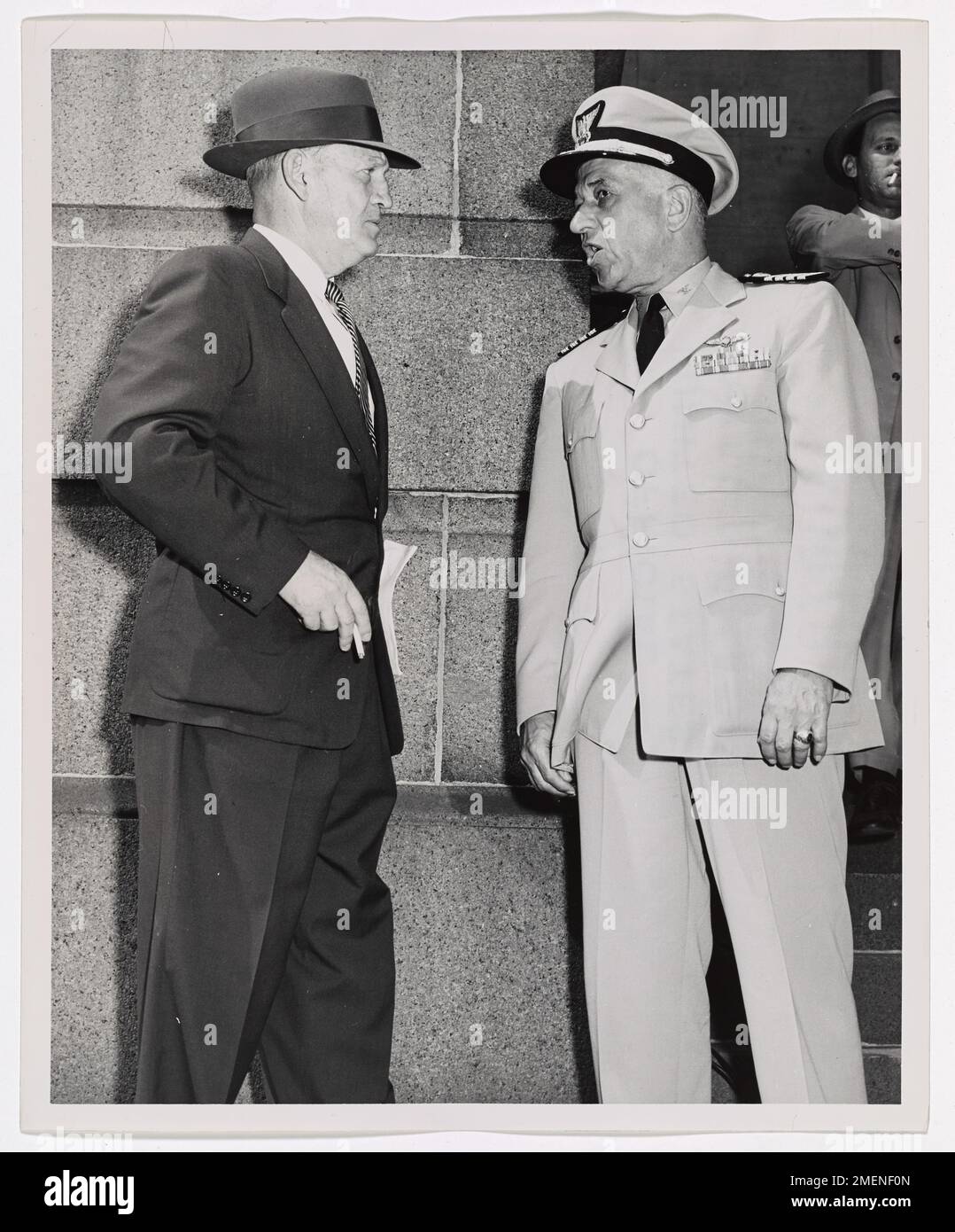 Captain Frank A. Leamy talks over UN Day activities with retired Navy Captain Thomas E. Lewis of the New Orleans Port Commission. Captain Frank A. Leamy, Commander, 8th Coast Guard District, New Orleans, talks over UN Day activities in front of New Orleans City Hall, with retired Navy Captain Thomas E. Lewis of the New Orleans Port Commission. Stock Photo