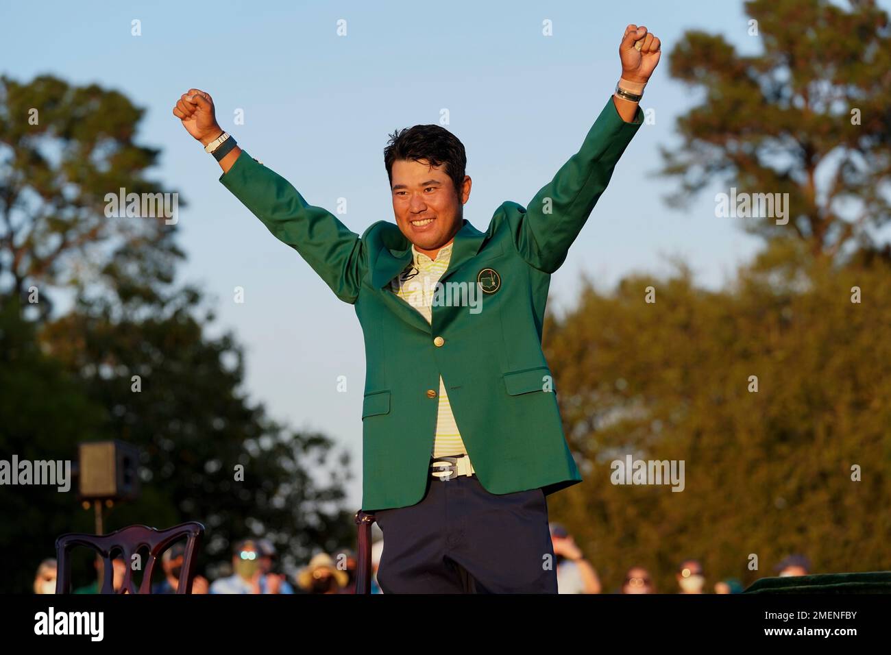 Hideki Matsuyama, of Japan, celebrates after putting on the champion's