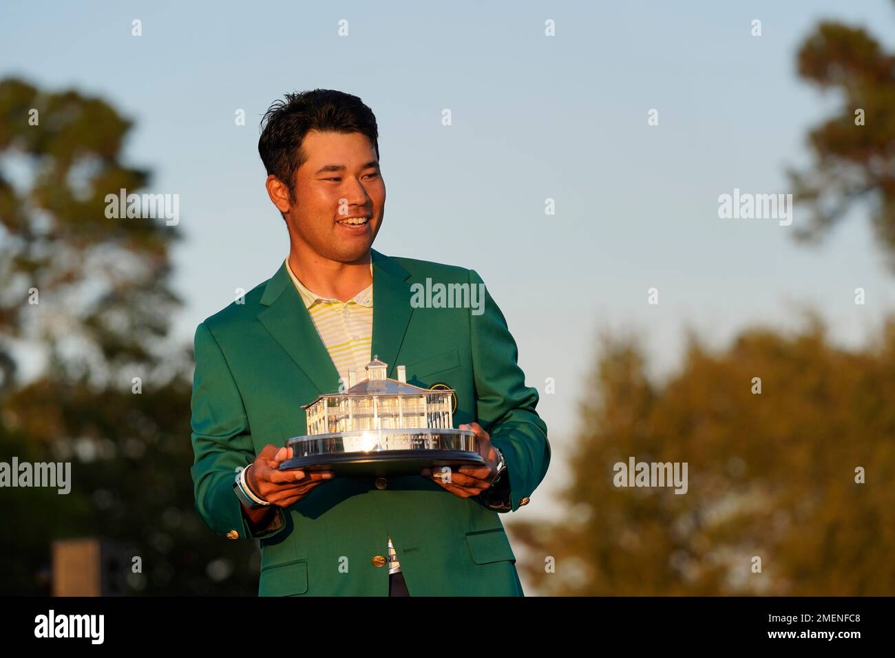 Hideki Matsuyama, of Japan, celebrates after putting on the champion's