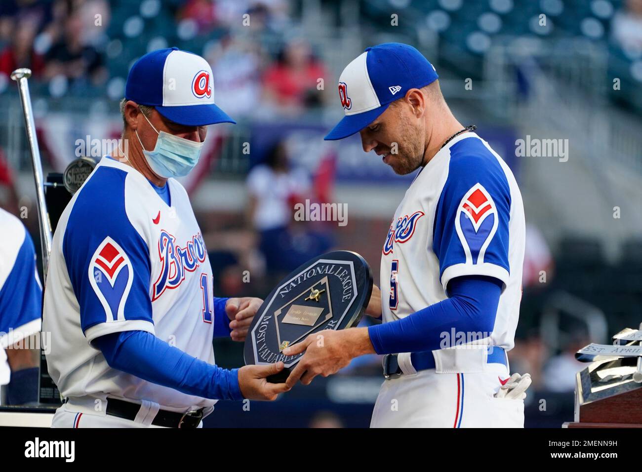 Former Atlanta Braves player Chipper Jones, left, presents the 2020  National League Most Valuable Player Award to Braves first baseman Freddie  Freeman before a baseball game against the Philadelphia Phillies, Sunday,  April