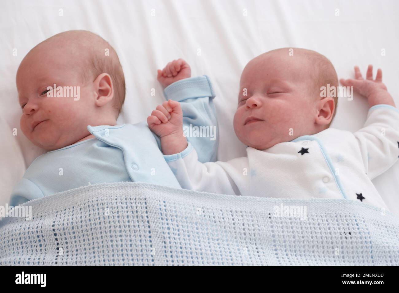 Twin baby boy and girl asleep in cot together, 5 months Stock Photo Alamy