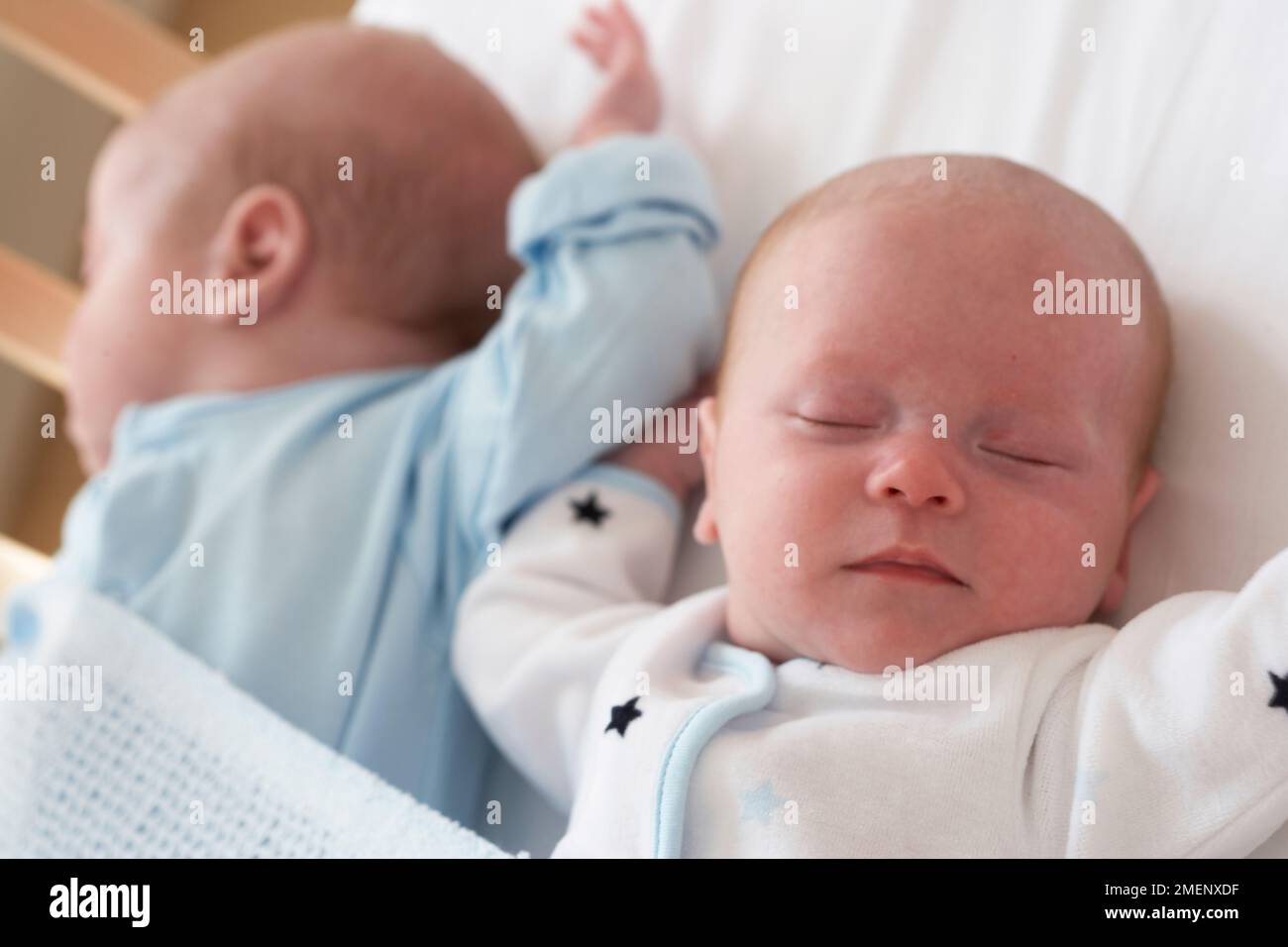 Twin baby boy and girl asleep in cot together, closeup, 5 months Stock