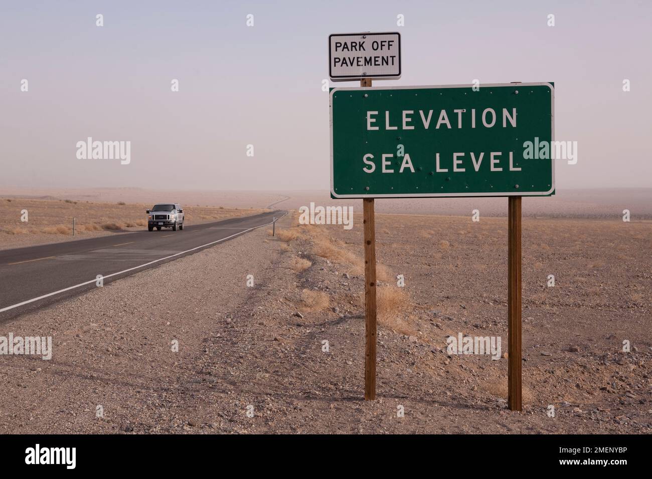 Elevation Sea Level sign and car on straight road at Death Valley National Park, California Stock Photo