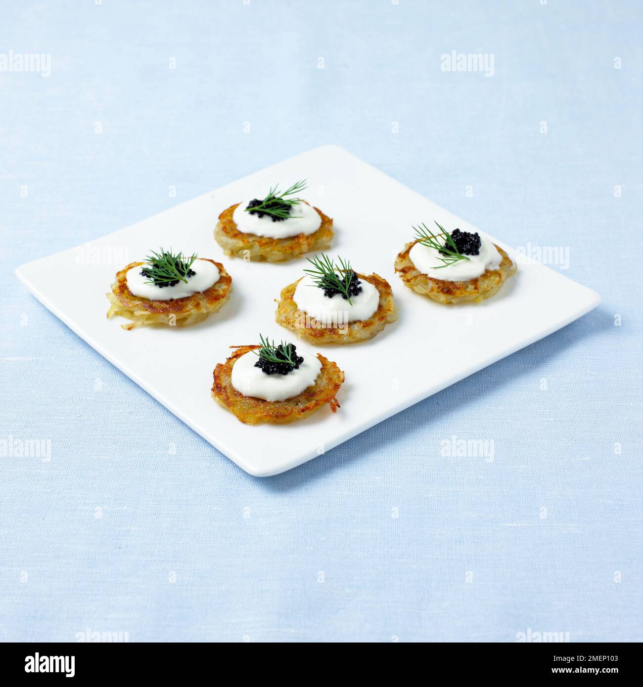 Mini rosti topped with creme fraiche, caviar and dill Stock Photo