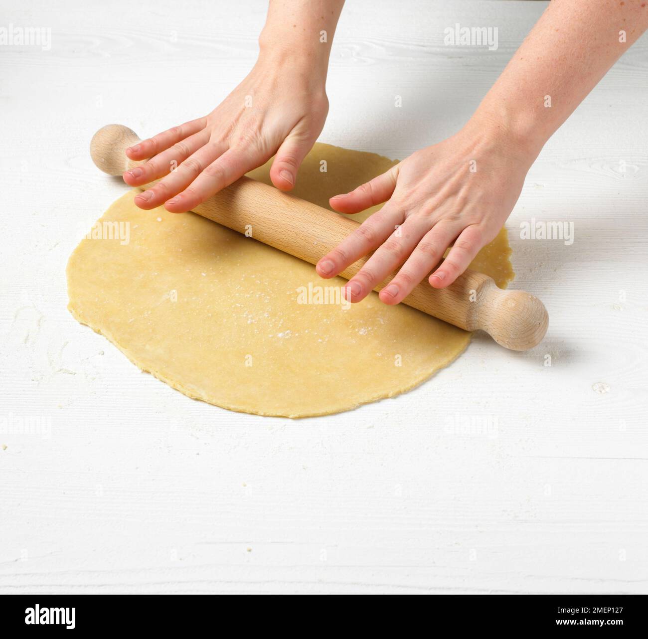 Using rolling pin to roll shortcrust pastry on floured worktop, closeup Stock Photo Alamy
