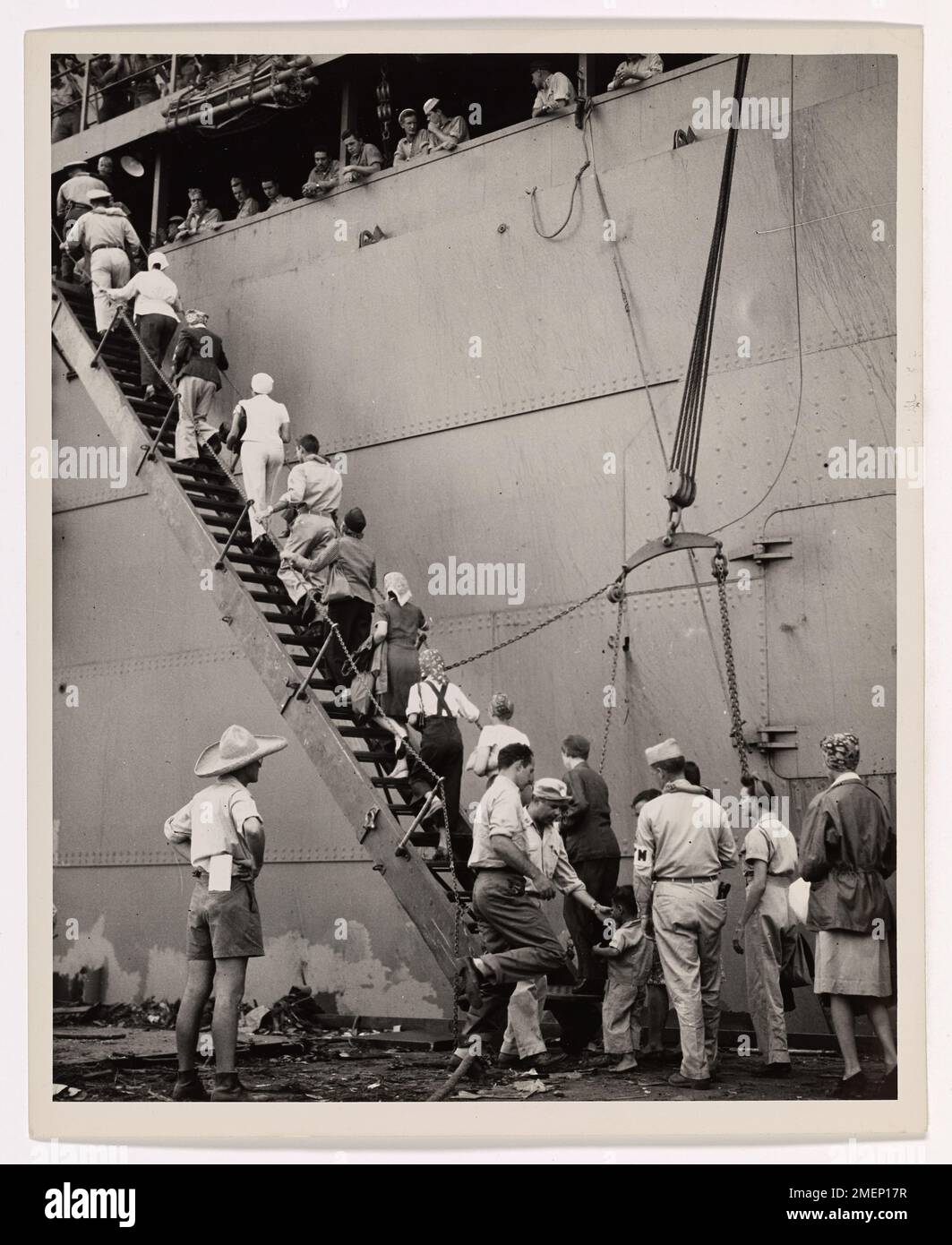 The Long Journey Home. Liberated from Jap prison camps I the Philippines, American and British internees climb the gangway to board the Coast Guard-manned troop transport which will carry them across the Pacific to the United States. Hundreds of men, women and children, who for three long years suffered from slow starvation in Los Banos and Santo Tomas prison camps, made the long journey to California after weeks of hospitalization and convalescence under protection of American Forces occupying the Manila area. Stock Photo