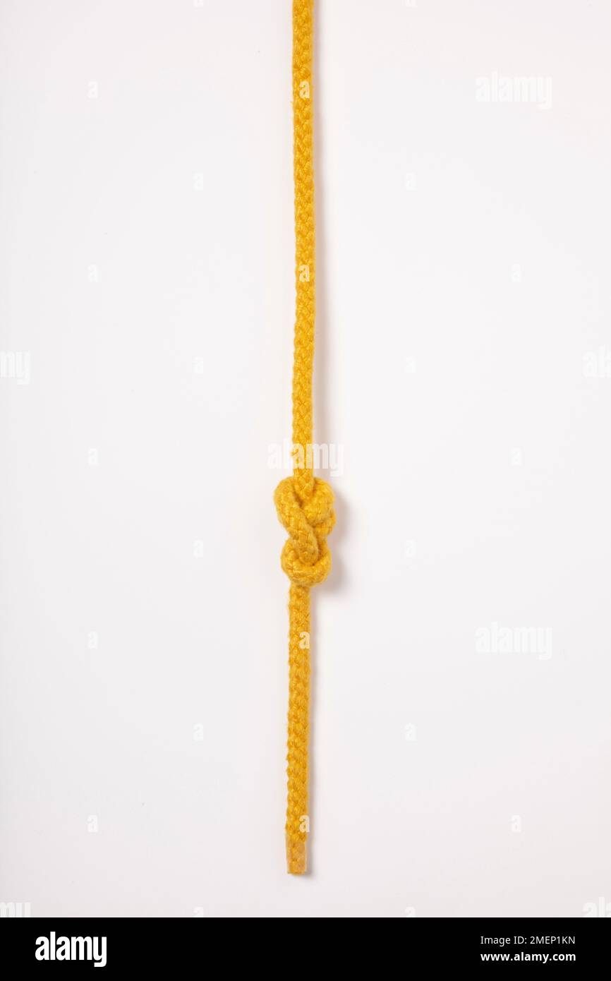 Stevedore knot, tied in yellow rope (stopper knot) Stock Photo