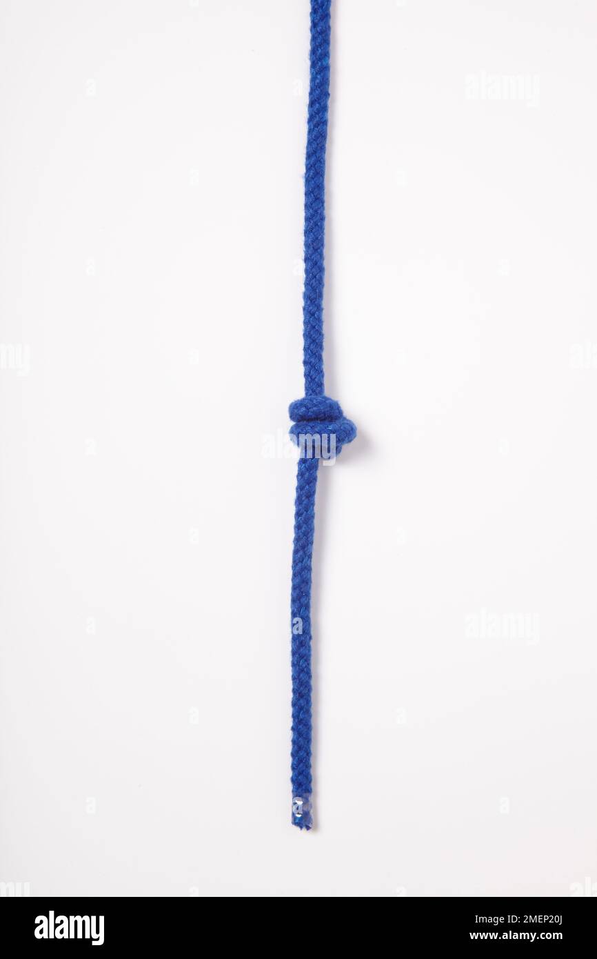 Double Overhand Knot, secure stopper knot tied in blue rope Stock Photo