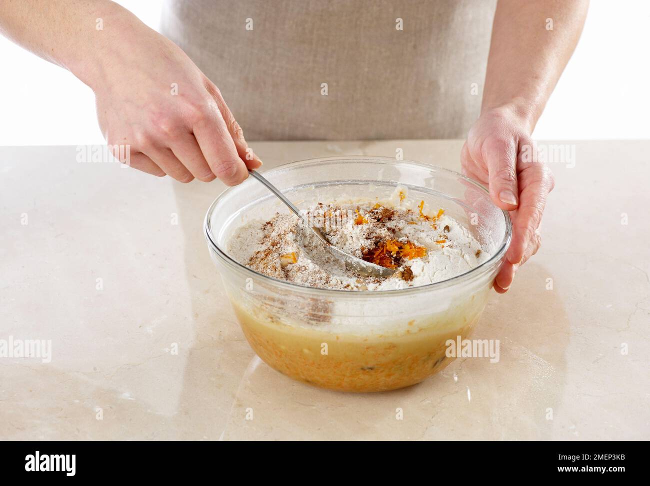 Making Carrot Cake, adding spices and orange zest and folding all