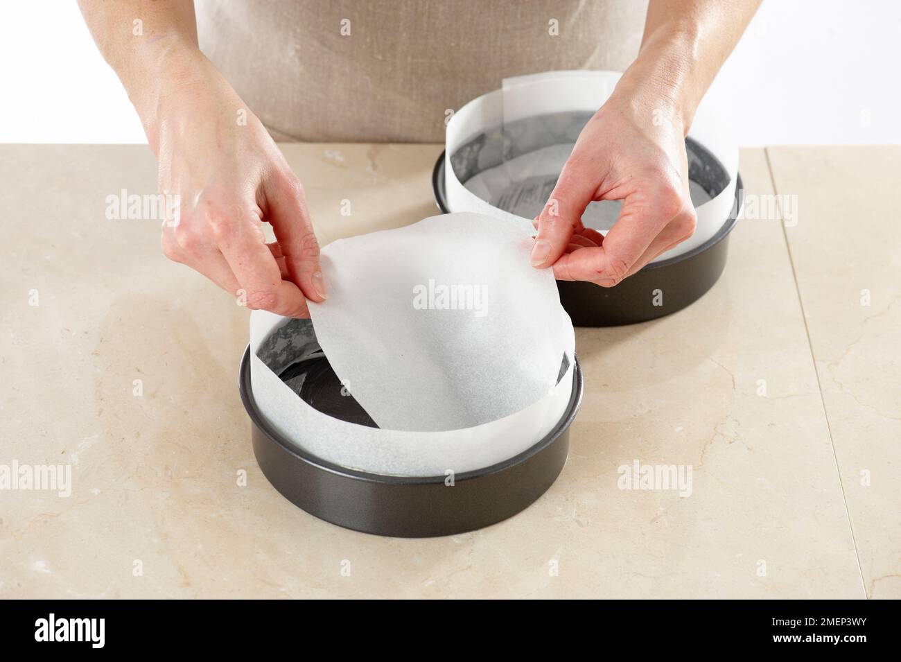 Chocolate Cake, lining the greased cake tins with baking parchment