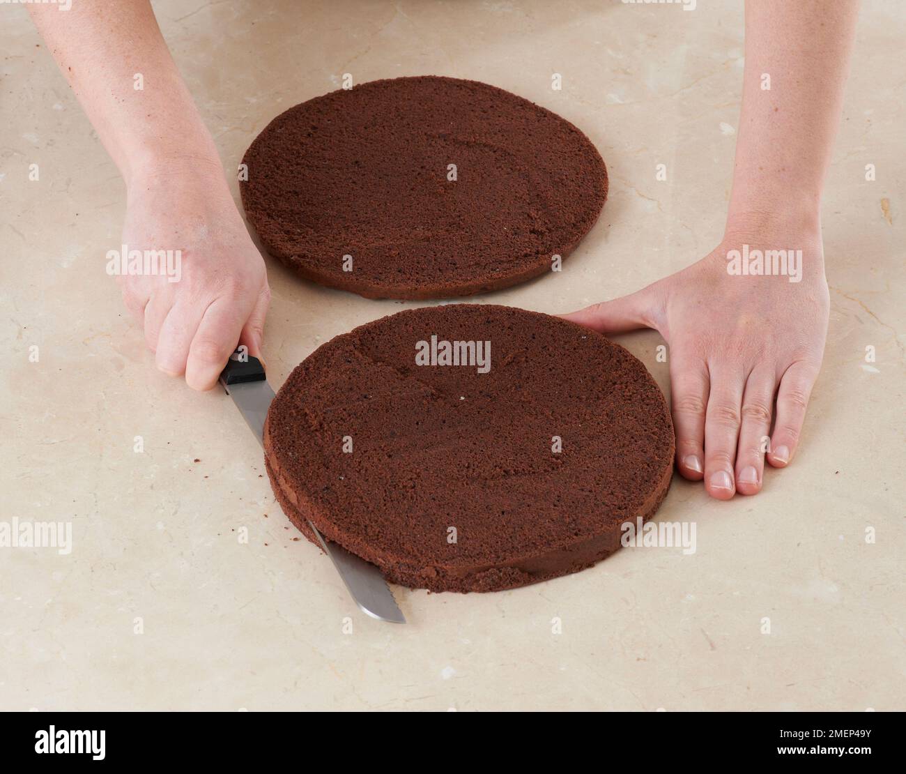 Black Forest Gateau, cutting cake into layers using serrated knife