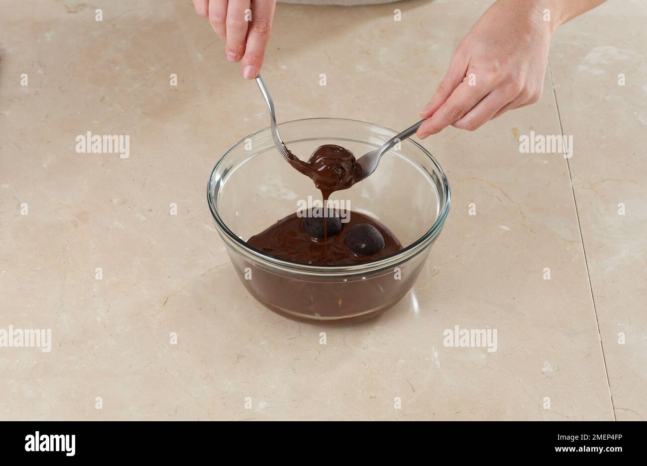 Chocolate Fudge Cake Balls, coating cake balls in chocolate Stock Photo