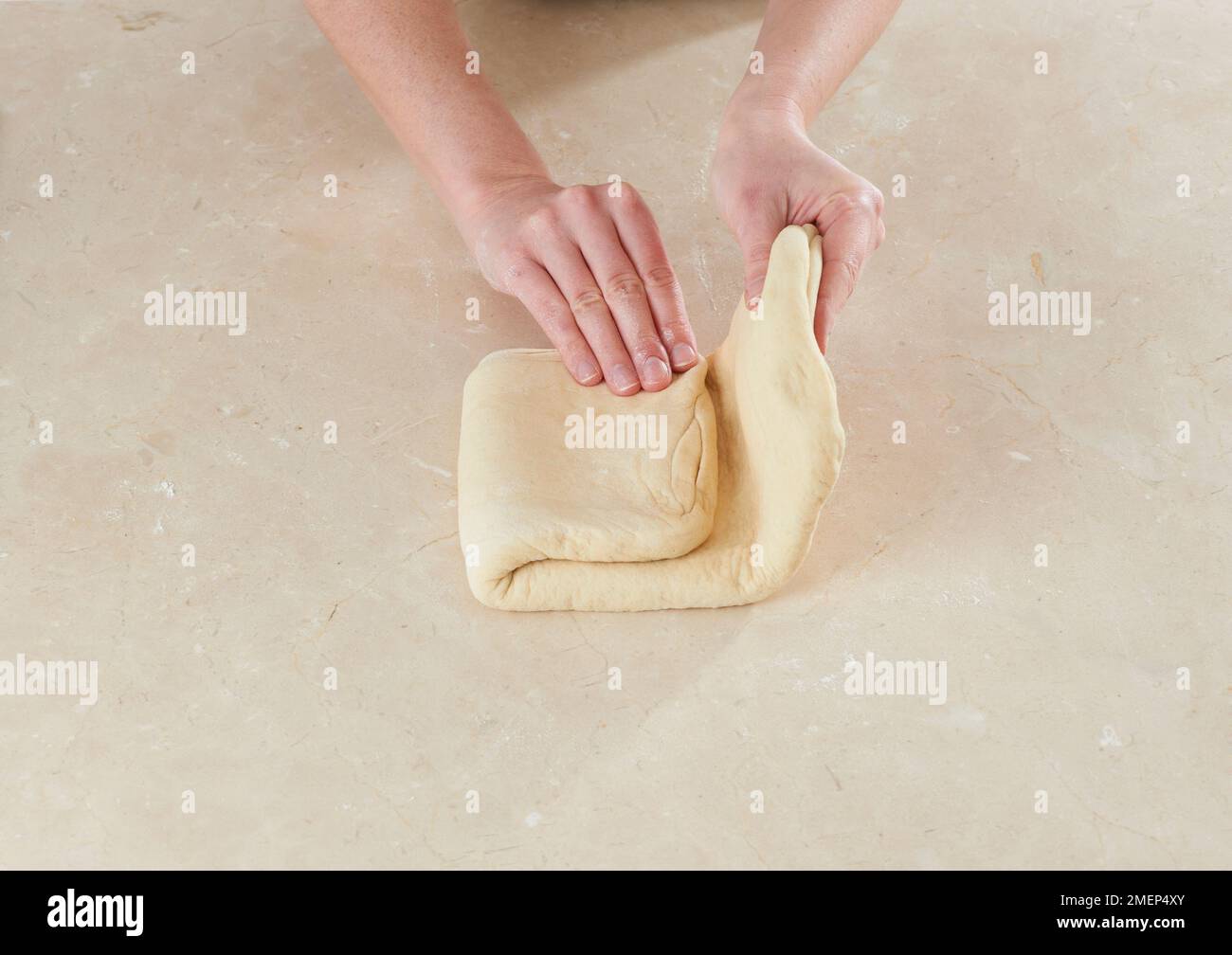 Making croissants, folding dough Stock Photo Alamy