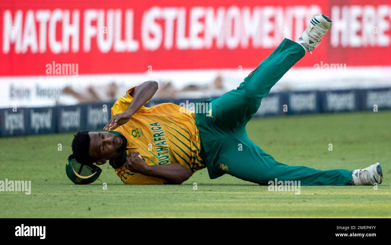 South Africas bowler Lizaad Williams falls on the ground after taking a catch to dismiss Pakistans captain Babar Azam for 14 runs during the first T20 cricket match between South Africa and