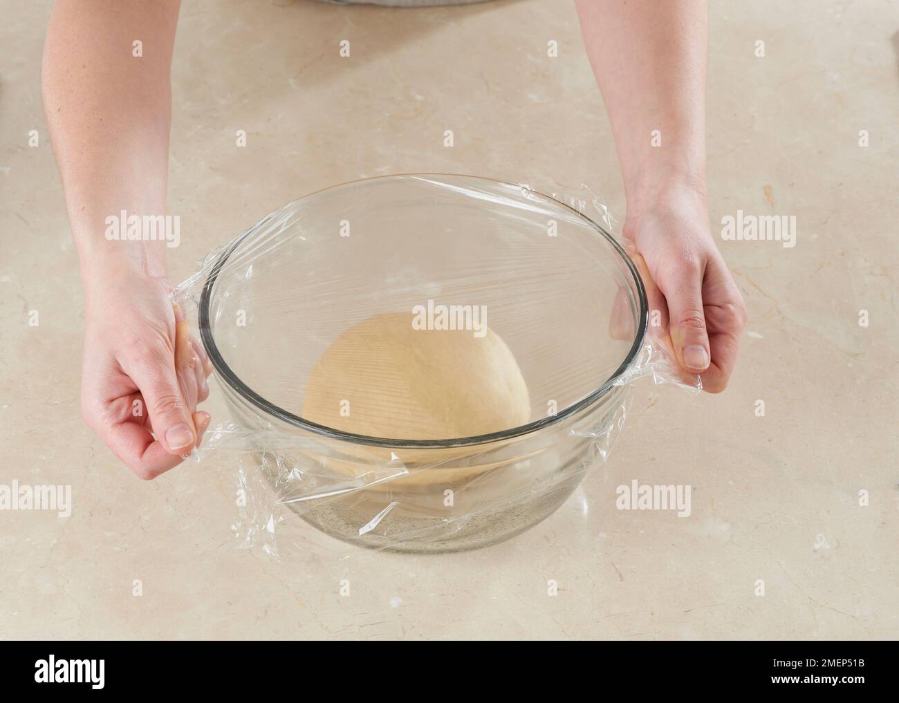 Making Danish Pastries, covering dough with cling film Stock Photo Alamy